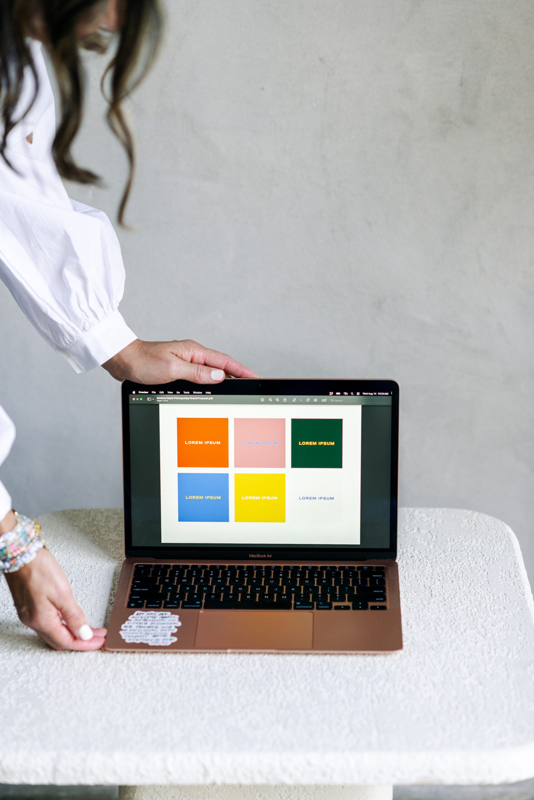 Close-up of a laptop displaying vibrant brand colors and design elements, symbolizing creativity and intentionality in visual storytelling for women entrepreneurs.